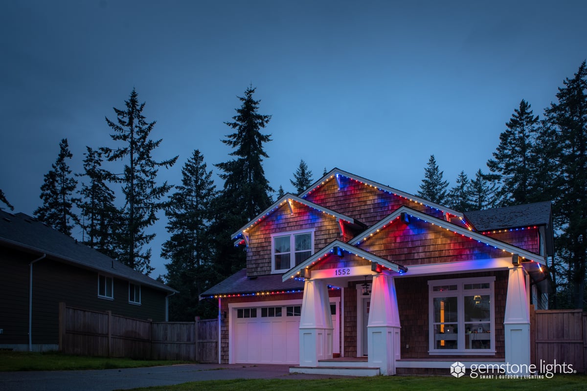 Two story house with multicolored roofline lighting